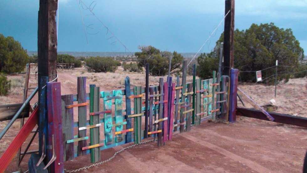 The colorful hand-built entrance gate at Hope Grows
